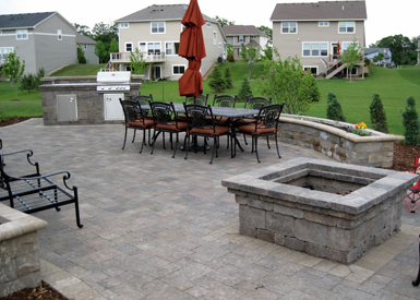 Outdoor kitchen, patio, and combination fire pit and table