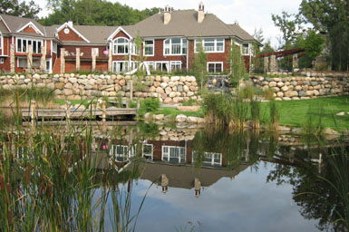 Pond with shoreline enhancement and boulder walls